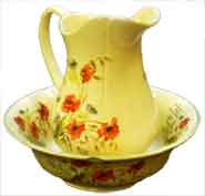 Old matching china flower-style jug and bowl for washing oneself where there was no access to a bathroom - common in the early 1900s.