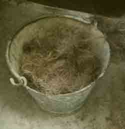 Bucket of teased out old rope fibres