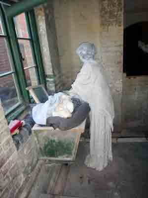 Woman workhouse inmate doing washing.