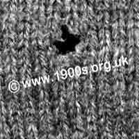 Damage from the clothes moth in a knitted woollen garment