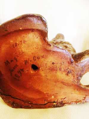 Underside of dog, highlighred, to show the maker's name and date