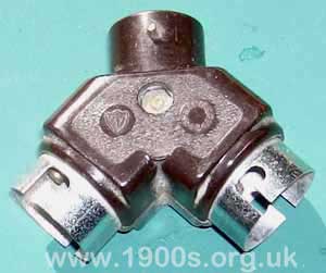 Early ceiling adapter to take an electric iron as well as a light bulb, standard in 1940s England and possibly before